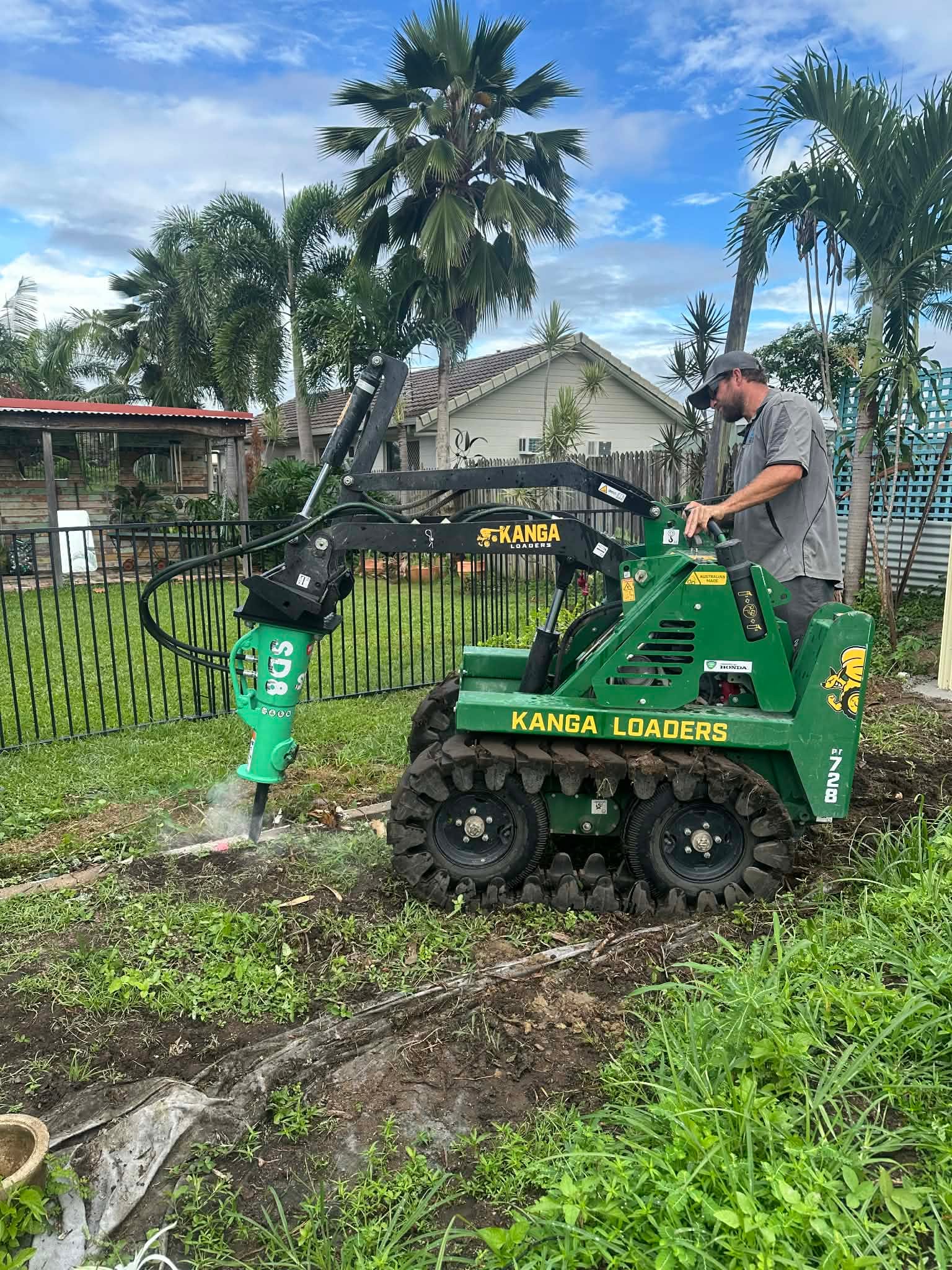 Mini loader with a rock breaker in Townsville