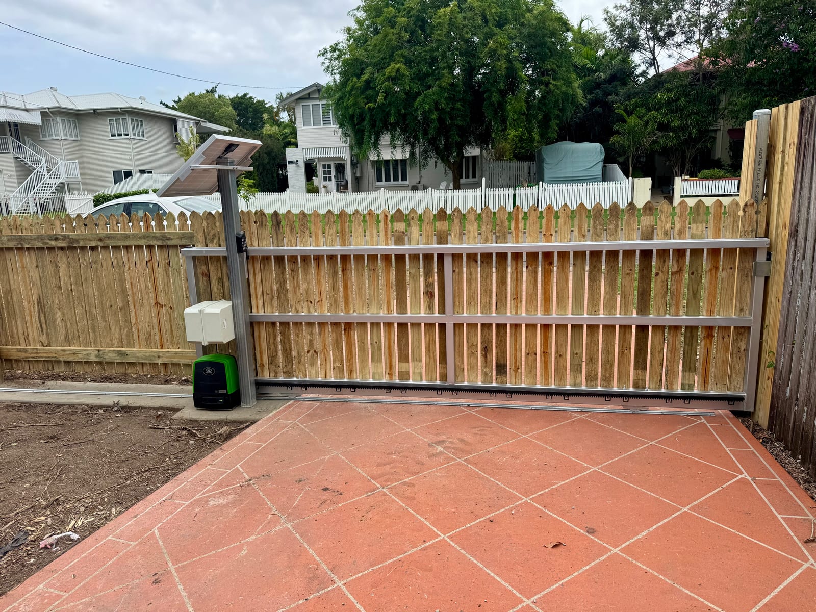 Timber gate with a solar light in Townsville