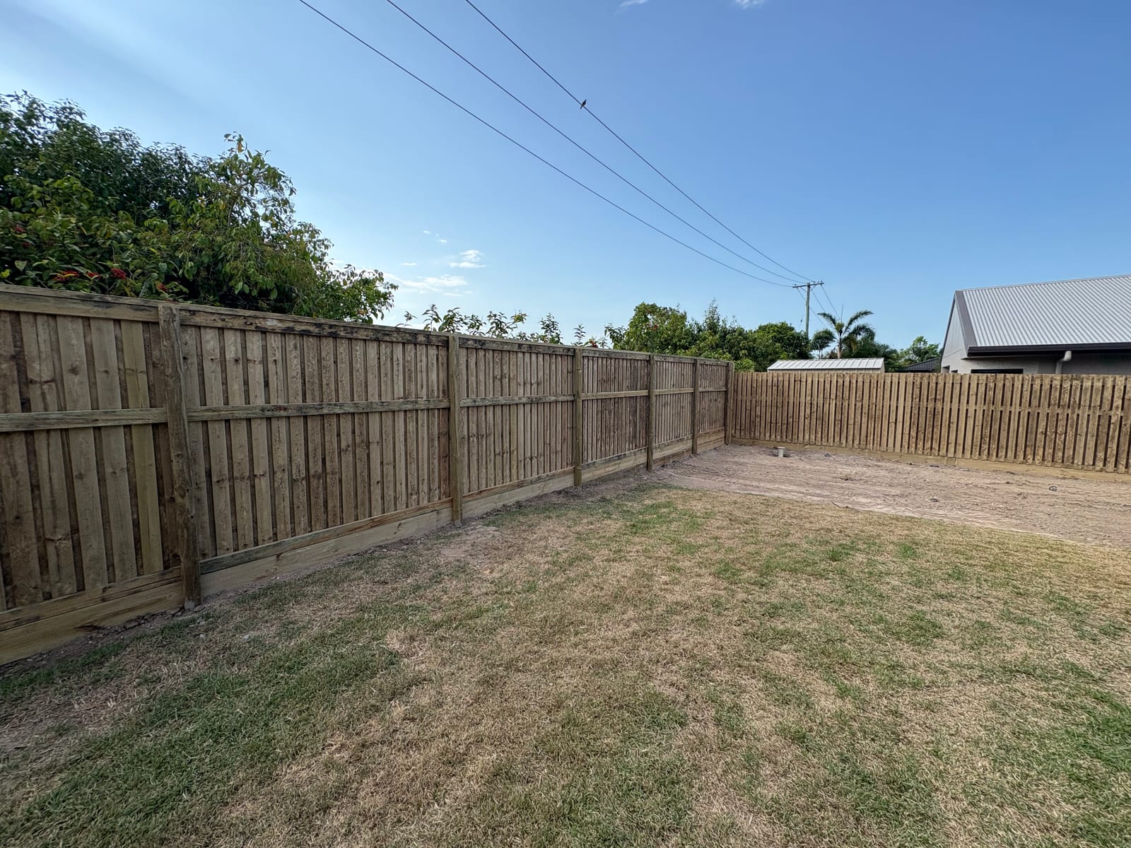 Timber paling fence along a Townsville backyard