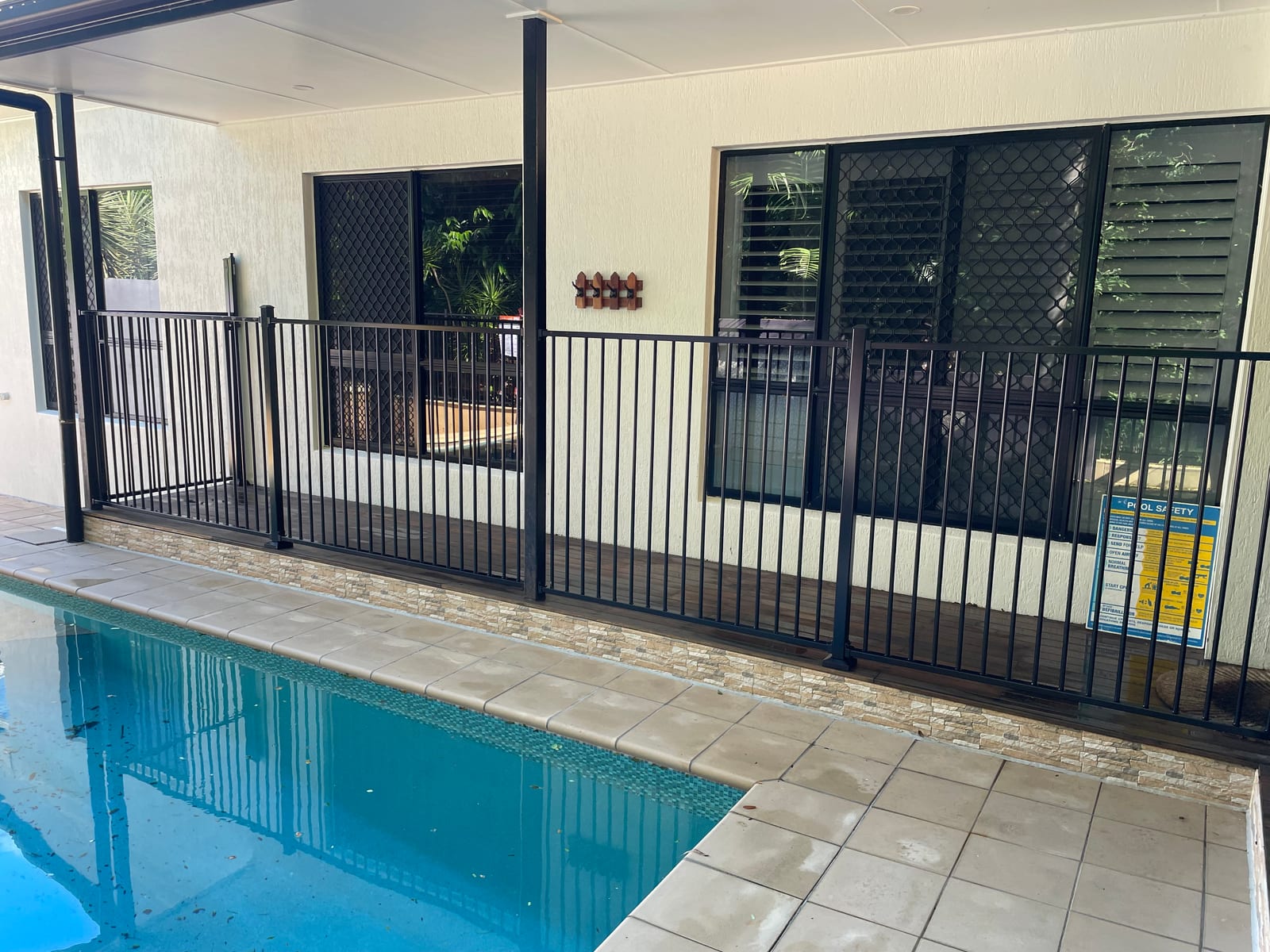 Black aluminium pool fence around a Townsville pool