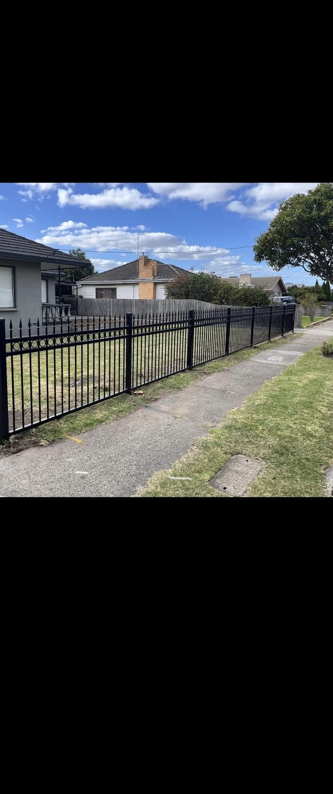 Black aluminium front fence on a Townsville home