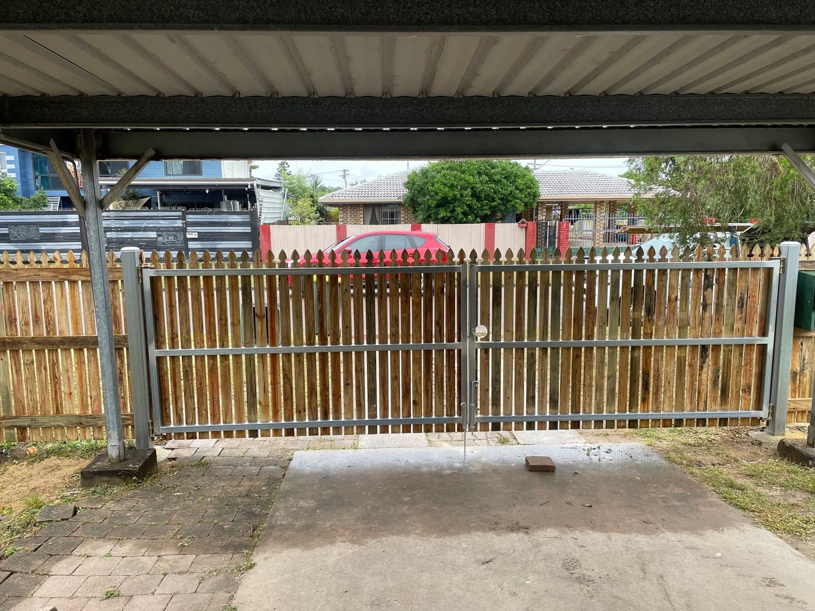 Timber double gates under a Townsville carport