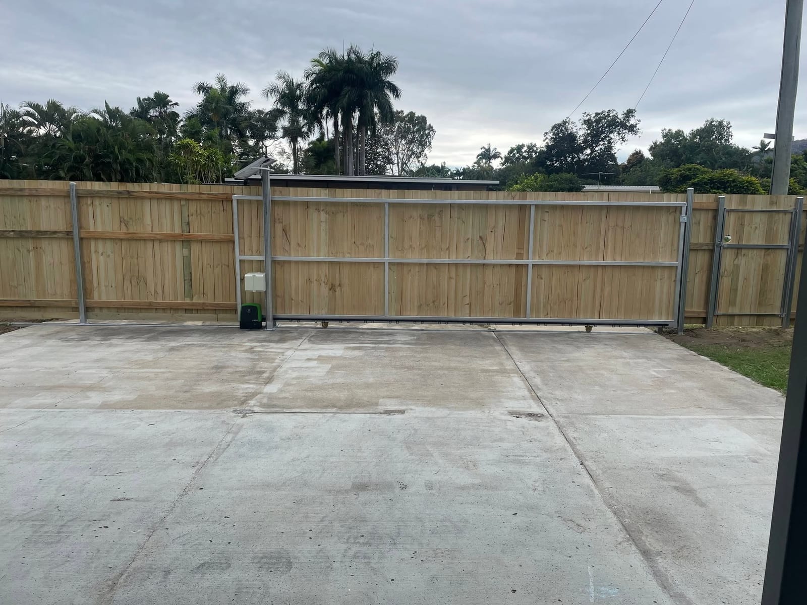 Timber sliding driveway gate installed by G & T Hire in Townsville