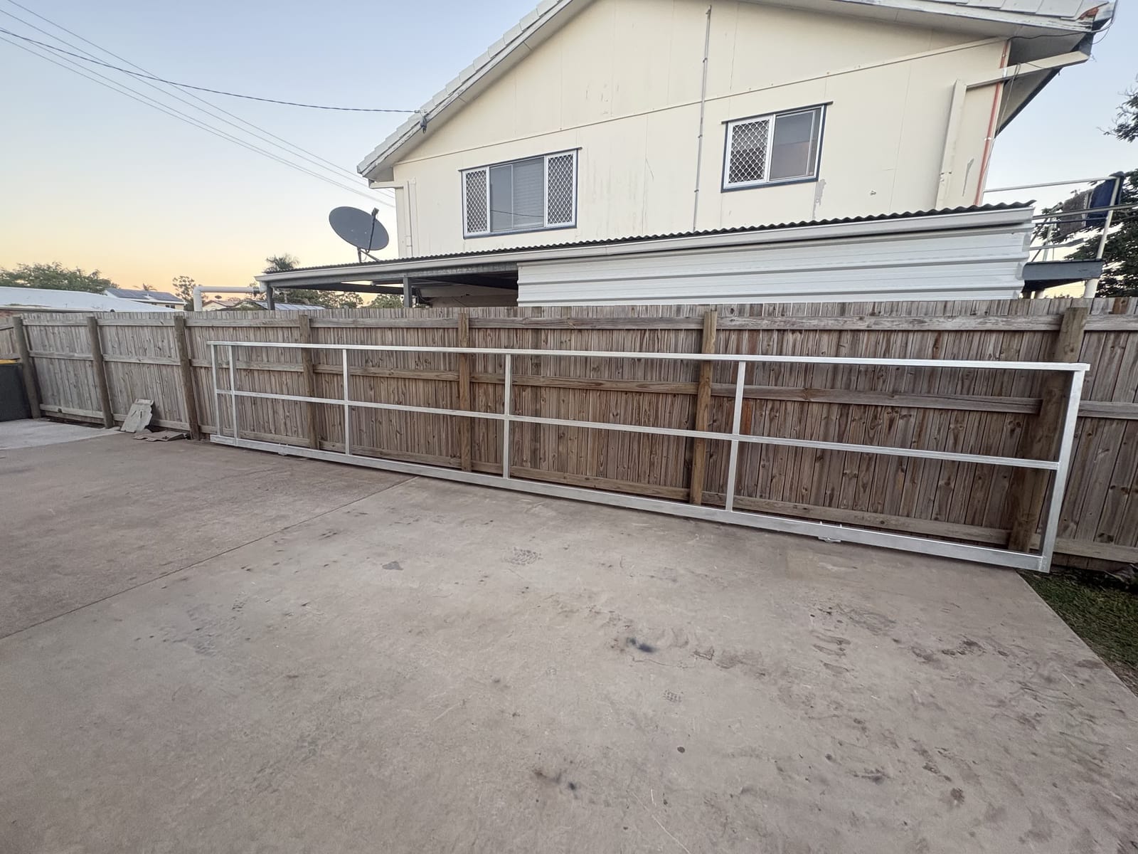 Steel-framed timber sliding gate on a Townsville driveway