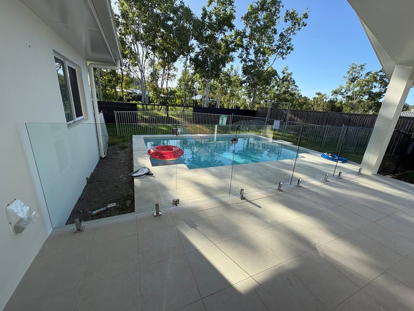 Glass pool fencing with spigots on a new Townsville pool