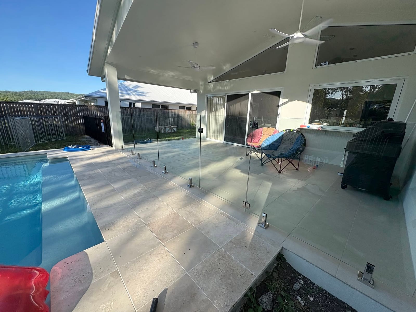 Glass pool fencing around an entertaining area in Townsville