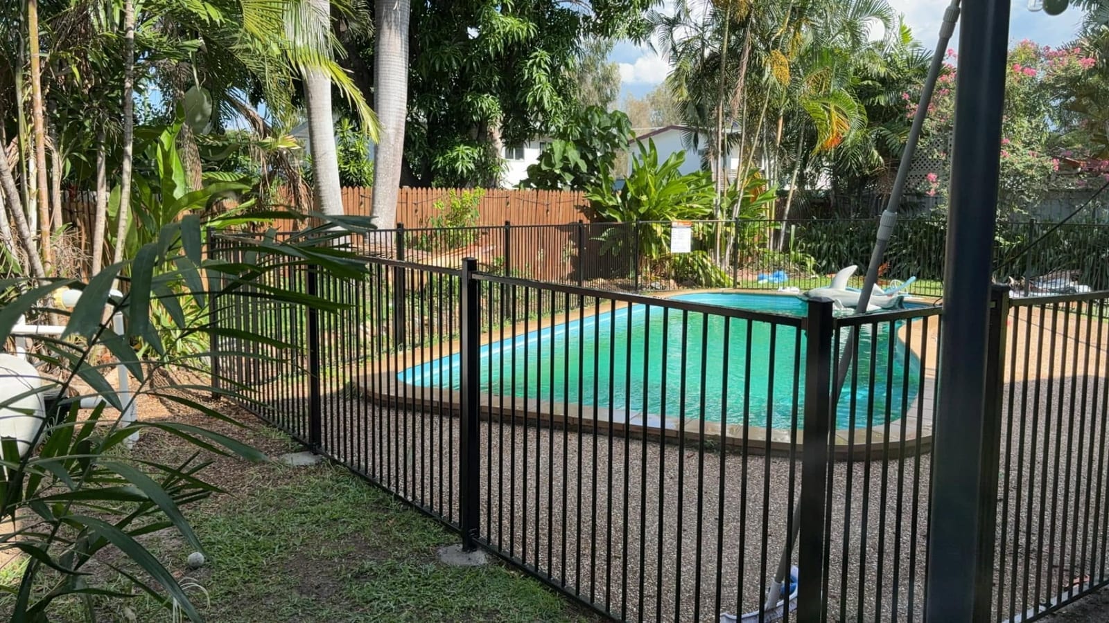 Black aluminium pool fence around a Townsville backyard pool