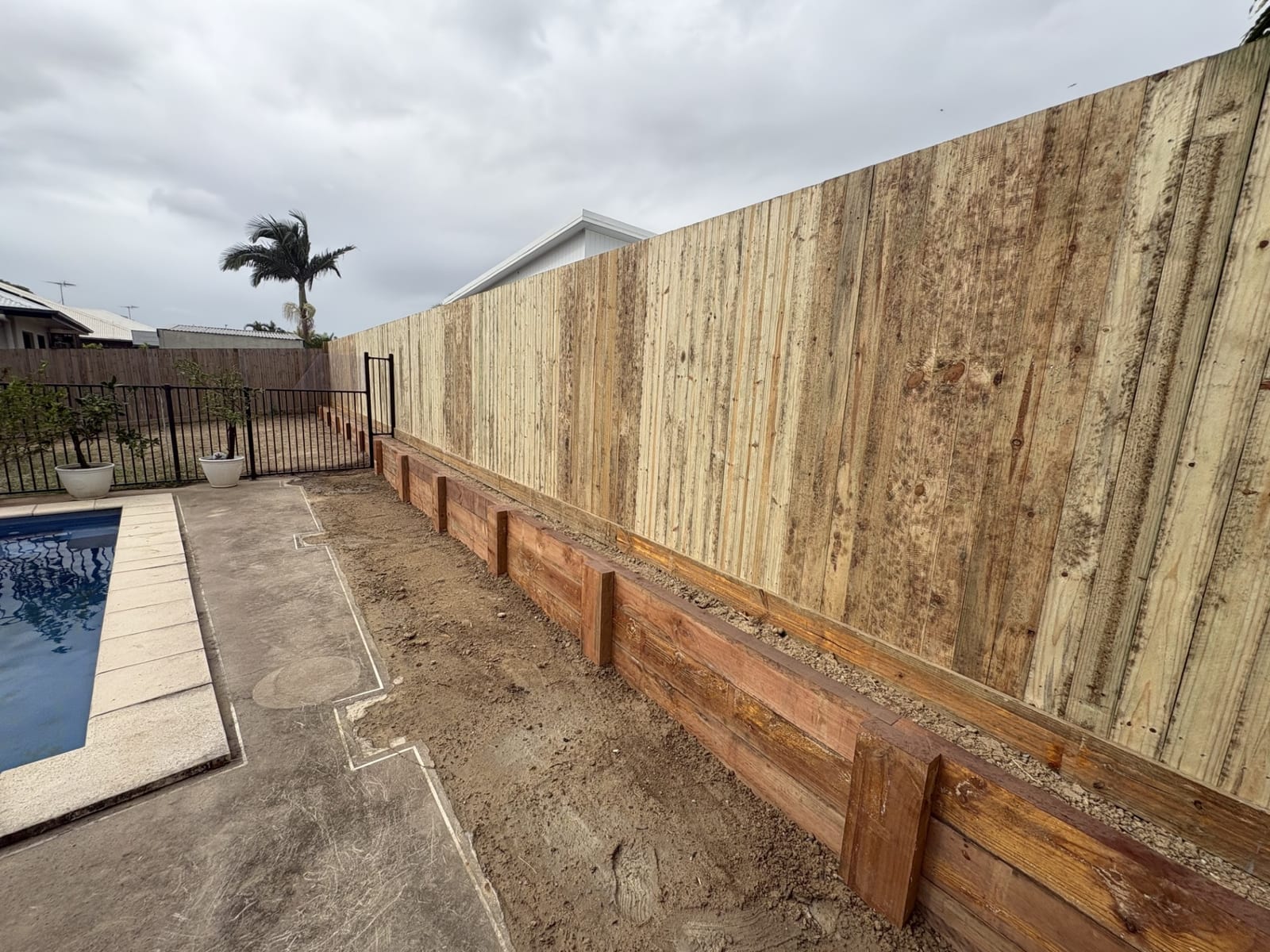 Timber sleeper retaining wall and fence in Townsville