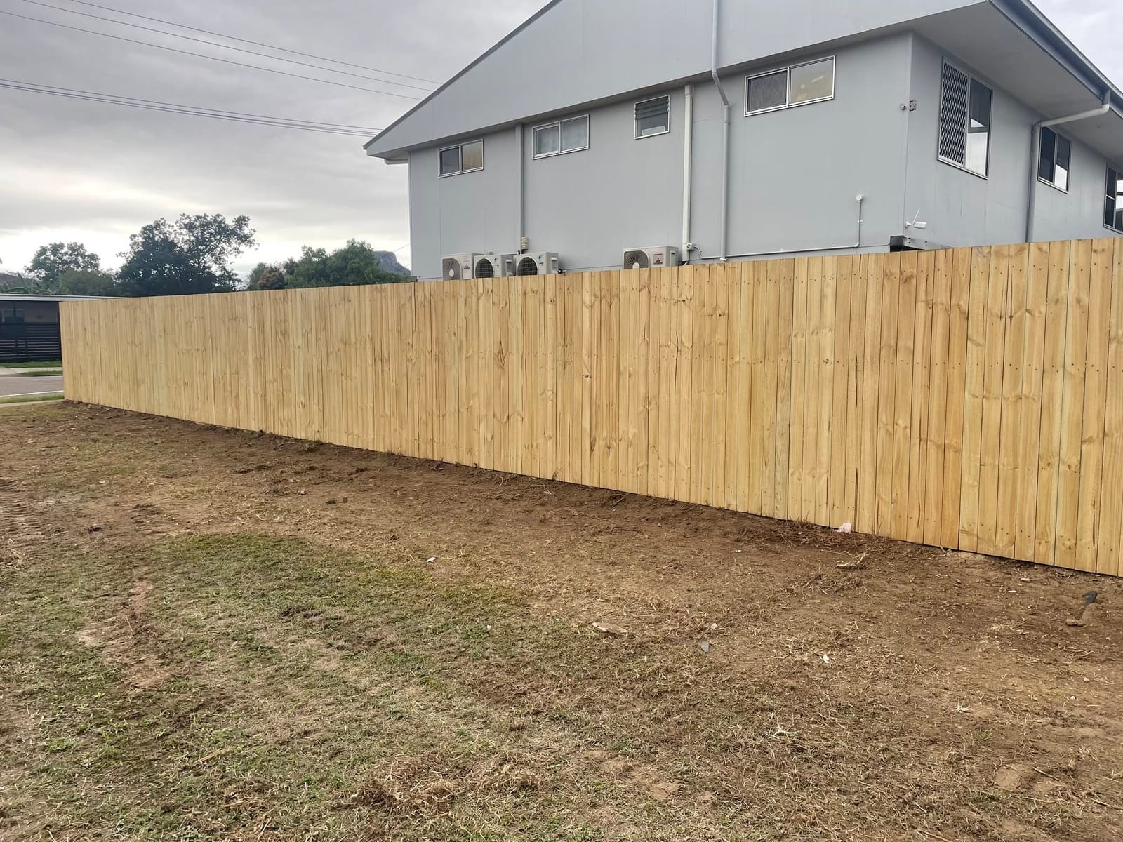 Long timber paling fence run in Townsville