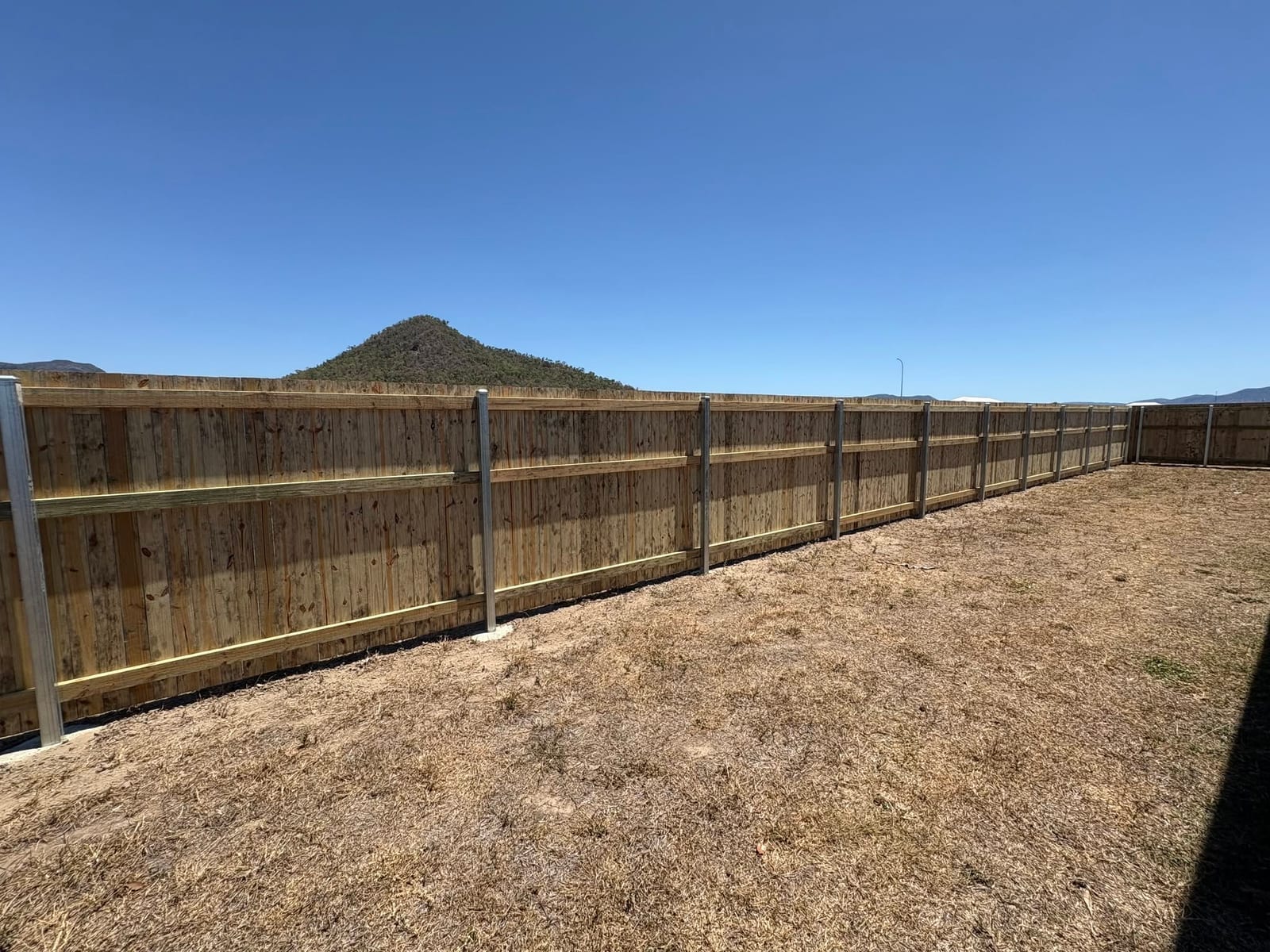 Timber fence with the Townsville range behind