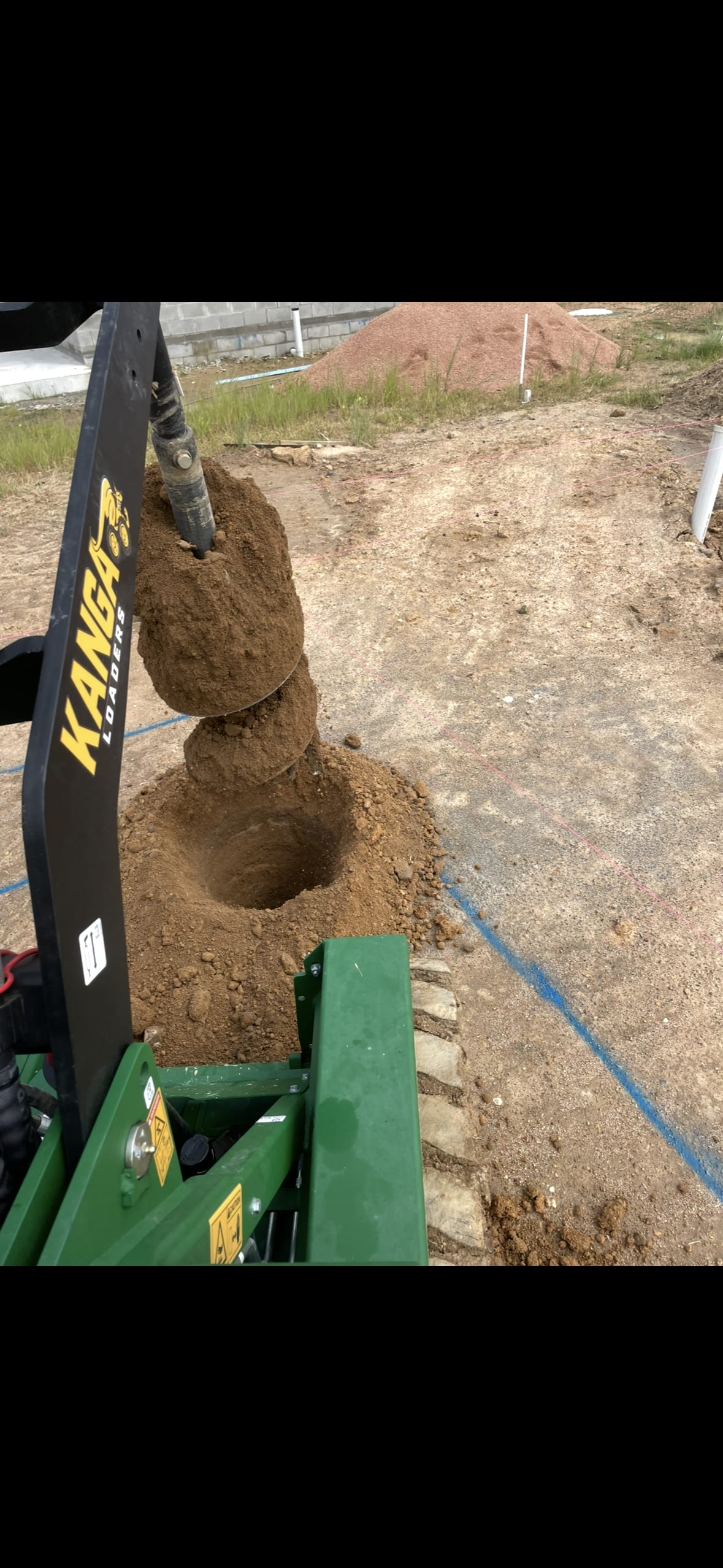 Augering post holes with a Kanga loader, Townsville