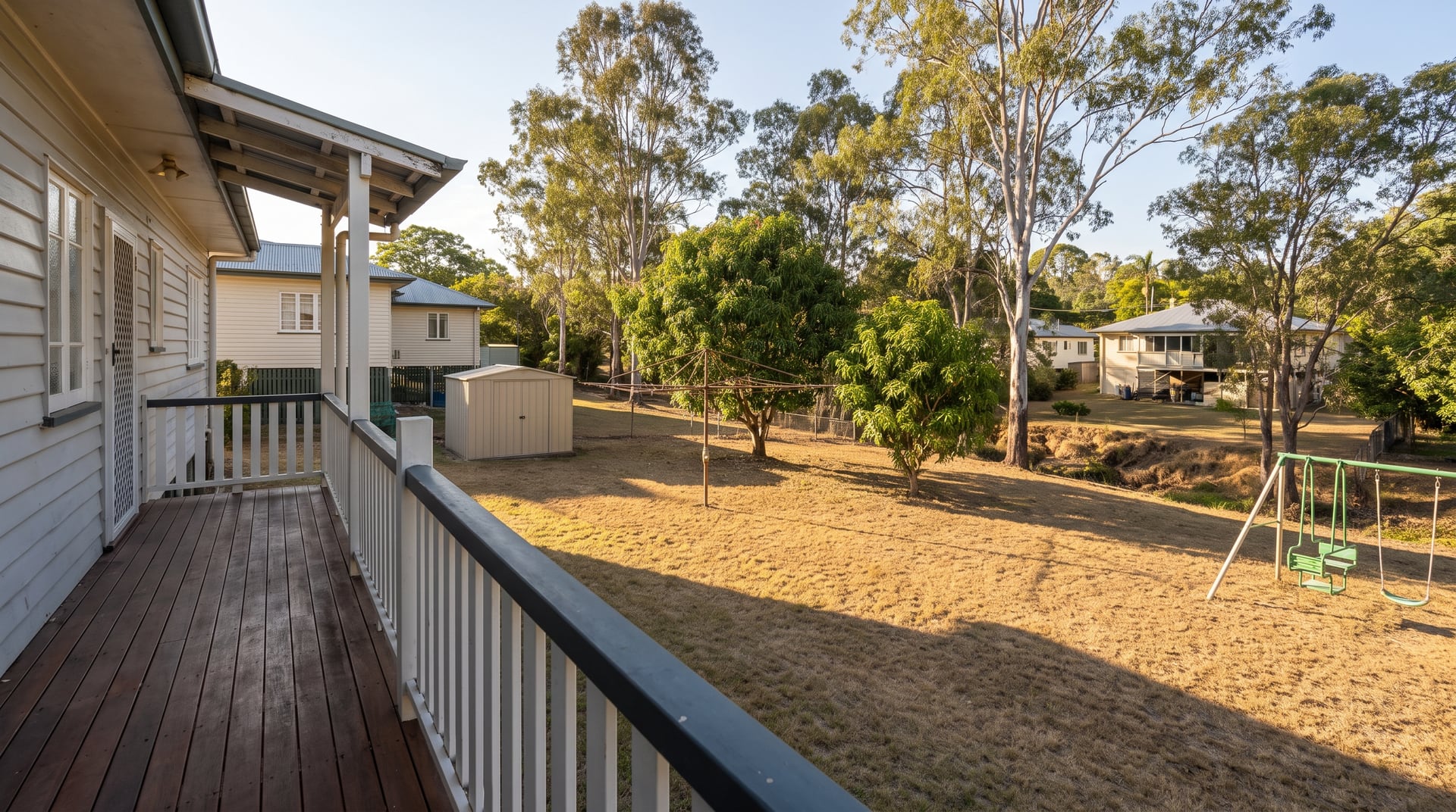 Backyard in Townsville before fencing — open, unfenced boundary